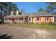 Charming single-story home featuring a welcoming front porch and vibrant red shutters at 210 Cowan Se Rd, Conyers, GA 30094