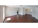 Comfortable living room with wood floors, neutral walls, and doorway to bathroom at 210 Cowan Se Rd, Conyers, GA 30094