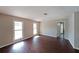 Bright living room with wood floors and natural light from the two large windows at 210 Cowan Se Rd, Conyers, GA 30094