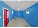 An empty room featuring vibrant blue walls, a tiled floor, and a doorway with a red curtain at 210 Cowan Rd Se, Conyers, GA 30094