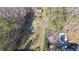 Aerial view of the property showing treeline and inground pool at 210 Cowan Se Rd, Conyers, GA 30094