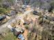 Expansive aerial view of the property in a serene, wooded neighborhood setting at 303 Wood Wind Dr, Woodstock, GA 30189