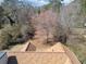 Top-down image displaying roof and surrounding landscape of mature trees at 303 Wood Wind Dr, Woodstock, GA 30189