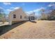 Exterior view of a charming single-Gathering home with a large, well-maintained yard at 303 Wood Wind Dr, Woodstock, GA 30189
