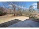 Backyard with dormant grass, patio and potential for landscaping and outdoor living at 303 Wood Wind Dr, Woodstock, GA 30189
