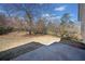 Spacious backyard with dormant grass, patio and potential for landscaping and outdoor living at 303 Wood Wind Dr, Woodstock, GA 30189