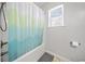 Bathroom featuring a shower/tub combo, a decorative shower curtain and a window at 303 Wood Wind Dr, Woodstock, GA 30189
