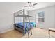 Bright bedroom with bunk beds, a ceiling fan, and a large window at 303 Wood Wind Dr, Woodstock, GA 30189