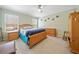 Bedroom with hardwood furniture, ceiling fan and carpet flooring at 303 Wood Wind Dr, Woodstock, GA 30189