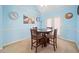 Cozy dining area with a wooden table set for four, bathed in natural light at 303 Wood Wind Dr, Woodstock, GA 30189