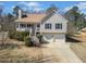 Charming two-story home with a welcoming front porch and attached two-car garage at 303 Wood Wind Dr, Woodstock, GA 30189