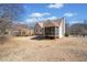 Exterior view of a charming single-Gathering home with a large, well-maintained yard at 303 Wood Wind Dr, Woodstock, GA 30189