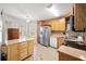 Bright kitchen with wooden cabinets, stainless steel appliances, and tiled floors at 303 Wood Wind Dr, Woodstock, GA 30189