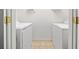 Laundry room with a full sized white washer and dryer at 303 Wood Wind Dr, Woodstock, GA 30189