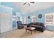 Inviting living room features neutral decor, a large window, and a ceiling fan at 303 Wood Wind Dr, Woodstock, GA 30189
