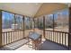 Screened porch with a table and chairs overlooking the backyard at 303 Wood Wind Dr, Woodstock, GA 30189