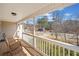 Relaxing covered front porch with rocking chair and neighborhood view at 303 Wood Wind Dr, Woodstock, GA 30189