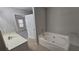 Bathroom with a soaking tub, tile floors, and a vanity with a sink at 115 Sunset Ln, Woodstock, GA 30189