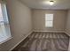 Bedroom featuring two windows, neutral paint and carpet at 115 Sunset Ln, Woodstock, GA 30189