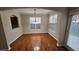 Bright dining room featuring hardwood floors, large windows, and a modern light fixture at 115 Sunset Ln, Woodstock, GA 30189