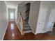 Inviting entryway showcasing hardwood floors, a staircase, and closet space at 115 Sunset Ln, Woodstock, GA 30189