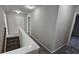 Upstairs hallway with neutral carpet and a white railing at 115 Sunset Ln, Woodstock, GA 30189