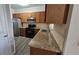 Functional kitchen featuring granite countertops, stainless steel appliances, and wood cabinets at 115 Sunset Ln, Woodstock, GA 30189
