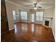 Open living room with hardwood floors, fireplace, and abundant natural light from multiple windows at 115 Sunset Ln, Woodstock, GA 30189