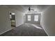 Main bedroom boasting a tray ceiling, carpeted floors and a large ensuite bathroom at 115 Sunset Ln, Woodstock, GA 30189