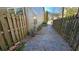 View of the side yard with gravel, bordered by wooden fences and the house's exterior at 115 Sunset Ln, Woodstock, GA 30189