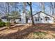 View of the home's backyard, complete with mature trees, a patio area, and a well-maintained exterior at 1876 Winding Creek Sw Ln, Marietta, GA 30064