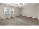 Spacious bedroom featuring a ceiling fan, neutral color palette, and natural light from a double window at 1876 Winding Creek Sw Ln, Marietta, GA 30064