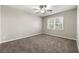 Bedroom featuring neutral carpet, a ceiling fan, and a window for natural light at 1876 Winding Creek Sw Ln, Marietta, GA 30064