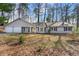 Charming single-story home with a two-car garage and a well-maintained front yard surrounded by mature trees at 1876 Winding Creek Sw Ln, Marietta, GA 30064