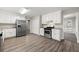 Well-lit kitchen featuring stainless steel appliances, white cabinetry, and ample counter space at 1876 Winding Creek Sw Ln, Marietta, GA 30064