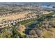 Aerial view of community featuring a pond and golf course surrounded by residential homes at 3313 Alhambra Cir, Hampton, GA 30228