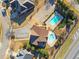 Aerial view of a community clubhouse and pool with parking and green spaces at 3313 Alhambra Cir, Hampton, GA 30228