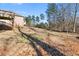Spacious backyard with mature trees and a gentle slope, ideal for outdoor activities at 3313 Alhambra Cir, Hampton, GA 30228
