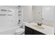 Bright bathroom featuring a shower and tub combination, dark fixtures, and a marble countertop at 3313 Alhambra Cir, Hampton, GA 30228