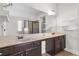 Well-lit bathroom with dual sinks, a mirror, and stylish shelving at 3313 Alhambra Cir, Hampton, GA 30228