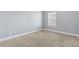 Neutral bedroom with gray walls, carpeted floor, and window view at 3313 Alhambra Cir, Hampton, GA 30228