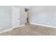 A neutral bedroom offering views to the laundry room and stairs at 3313 Alhambra Cir, Hampton, GA 30228