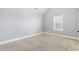 A comfortable bedroom featuring light walls, carpet, and a window at 3313 Alhambra Cir, Hampton, GA 30228