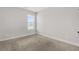 Bright bedroom with neutral carpet, a window, and fresh white trim at 3313 Alhambra Cir, Hampton, GA 30228