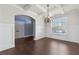 Bright dining area with wainscoting, coffered ceiling, dark floors, and a large window offering natural light at 3313 Alhambra Cir, Hampton, GA 30228