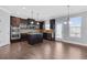 Open kitchen with stainless steel appliances, a center island, and dark cabinetry at 3313 Alhambra Cir, Hampton, GA 30228