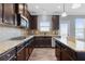 Spacious kitchen featuring stainless steel appliances, granite countertops, and a tile backsplash at 3313 Alhambra Cir, Hampton, GA 30228