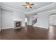 Inviting living room showcasing a cozy stone fireplace, hardwood floors, and crown molding at 3313 Alhambra Cir, Hampton, GA 30228