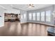 Open concept living room with hardwood floors and plenty of natural light open to the kitchen at 3313 Alhambra Cir, Hampton, GA 30228