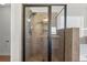 Modern walk-in shower with rainfall showerhead and built-in shelving at 3313 Alhambra Cir, Hampton, GA 30228